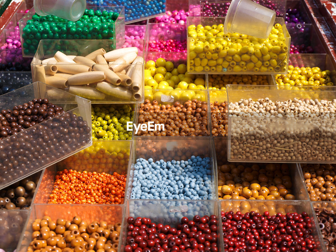 High angle view of colorful beads in containers at store