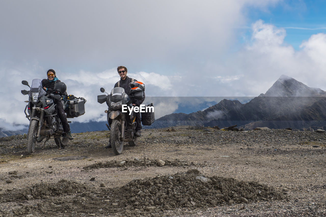 Couple on touring motorbikes at the pass of abra de malaga (4316 m)