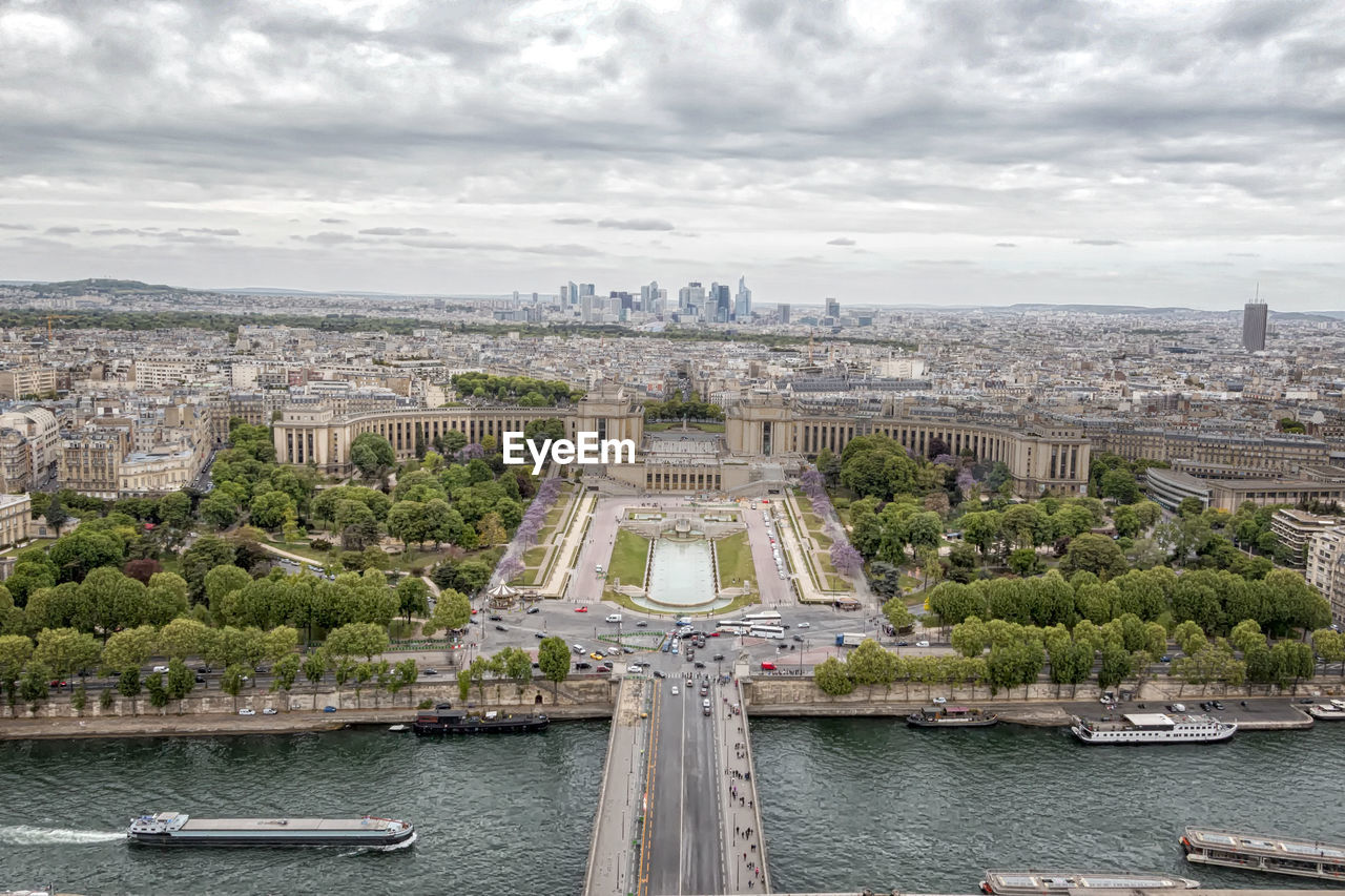 Aerial view of city against cloudy sky