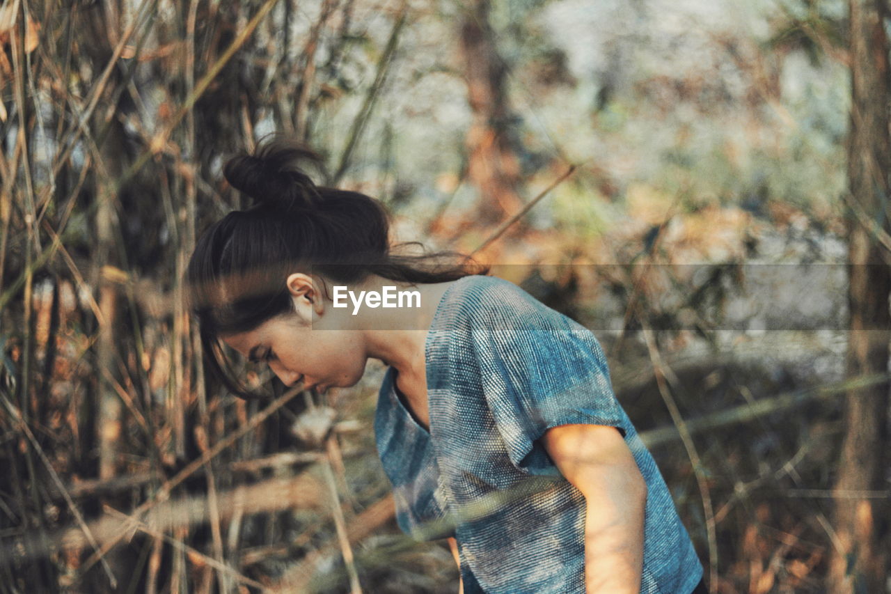 Side view of woman in forest