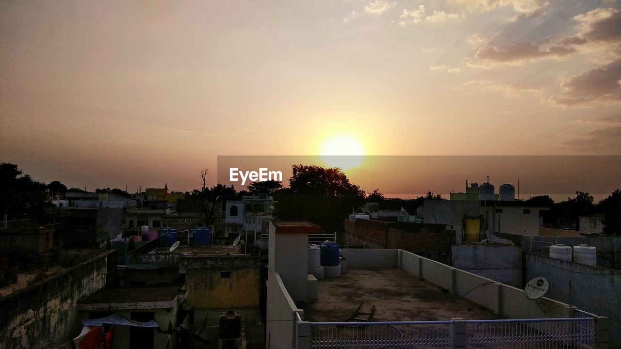 View of town against sky during sunset