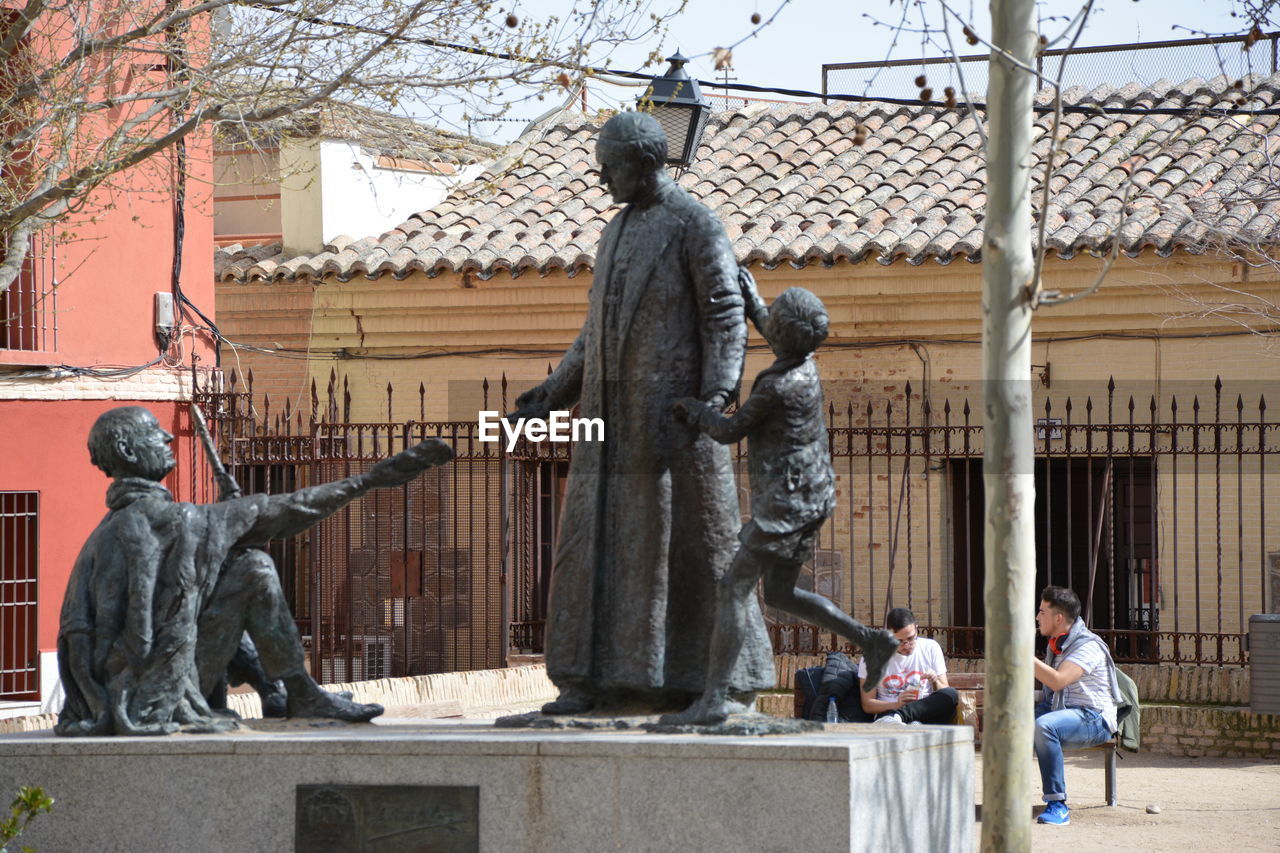 STATUE AGAINST BUILDING