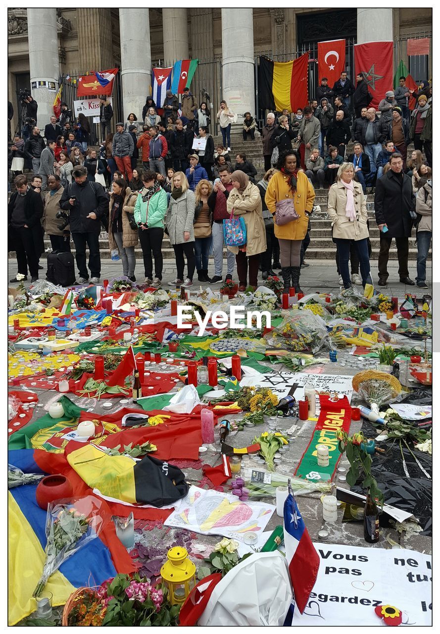 People looking at large group of objects on street