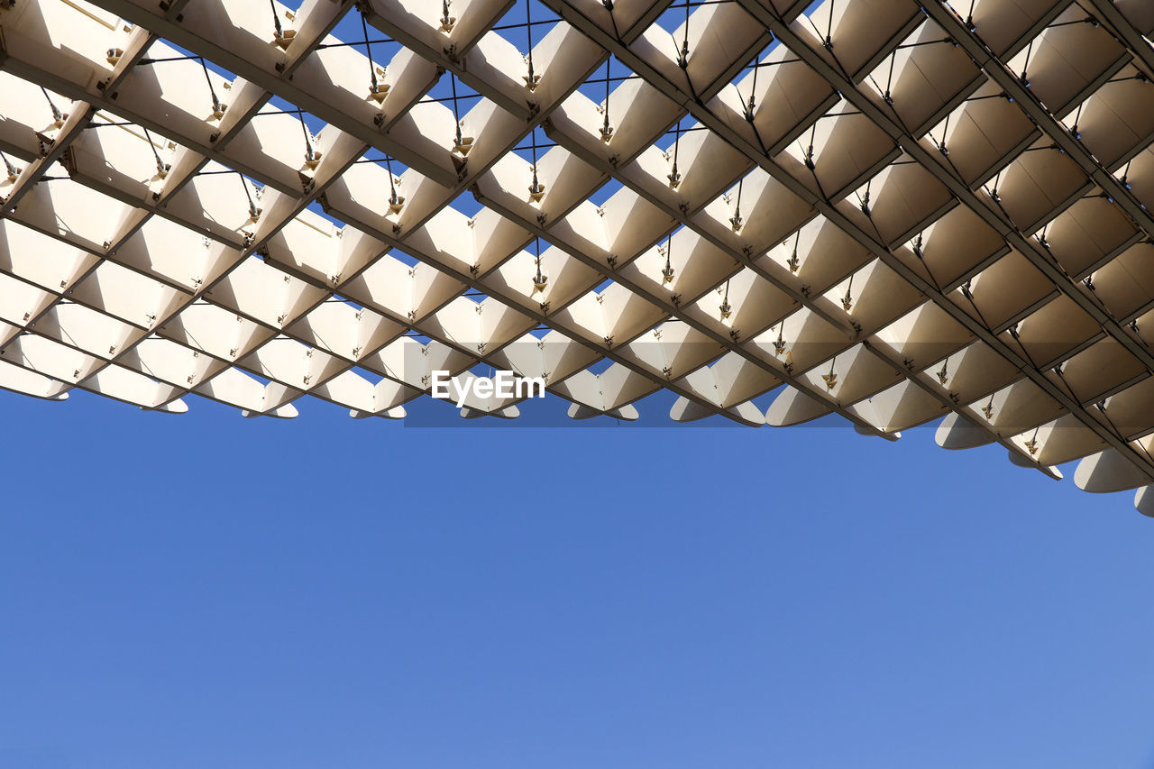 Low angle view of roof against blue sky