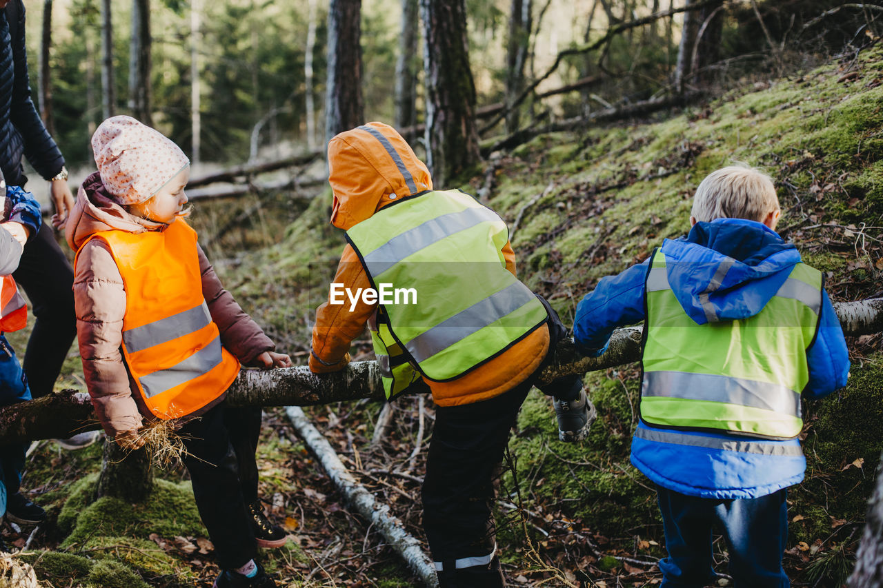 Rear view of children wearing reflective vests