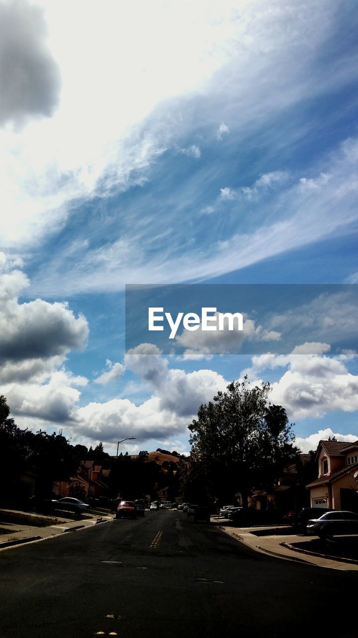 VIEW OF ROAD AGAINST CLOUDY SKY