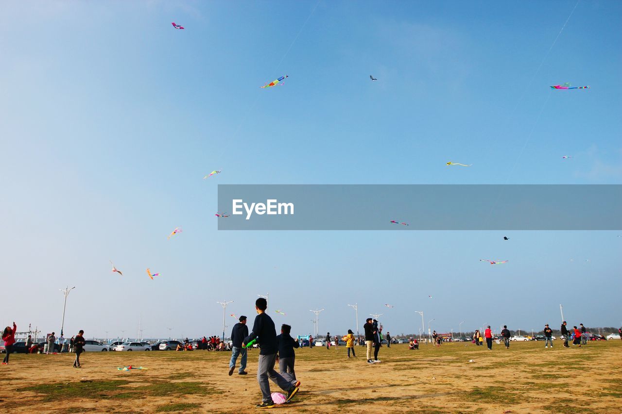 People enjoying at park against clear sky