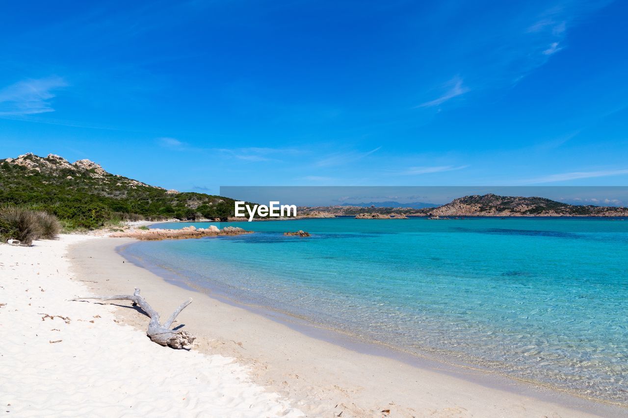 Scenic view of beach against blue sky
