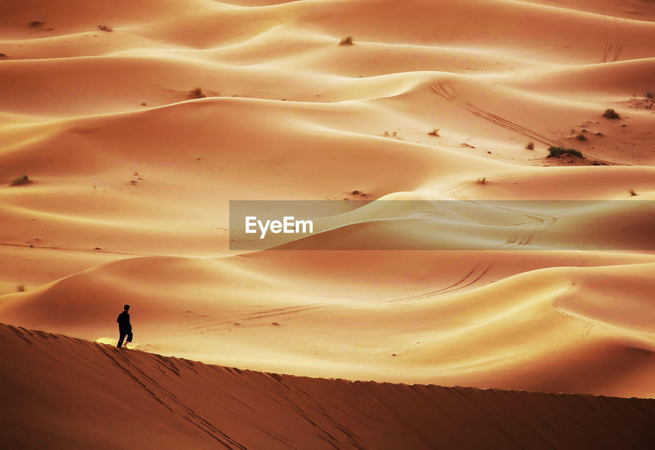 Man walking at erg chebbi desert