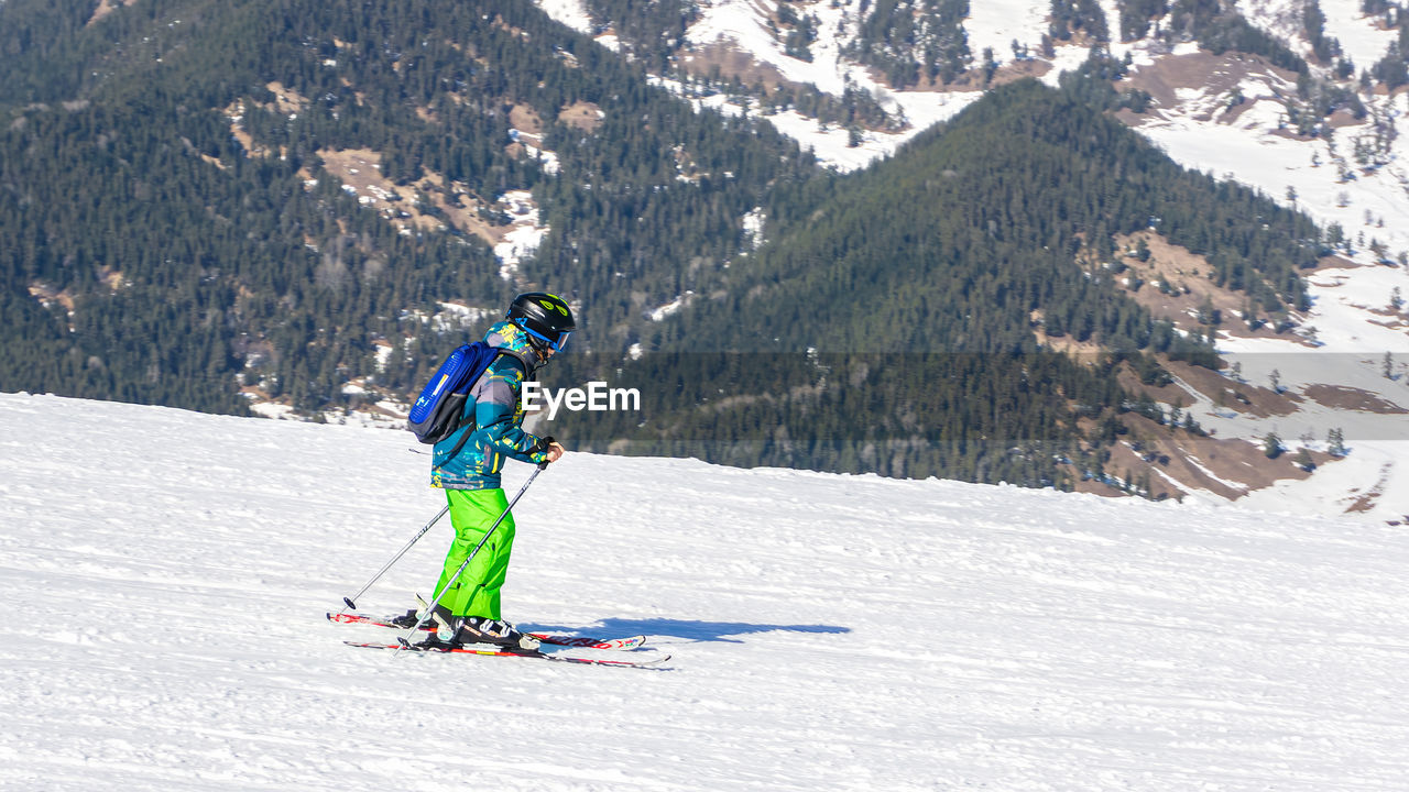 low angle view of man skiing on snowcapped mountain