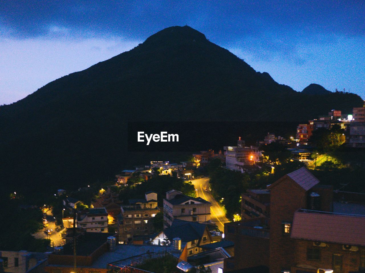 AERIAL VIEW OF ILLUMINATED TOWN AT NIGHT