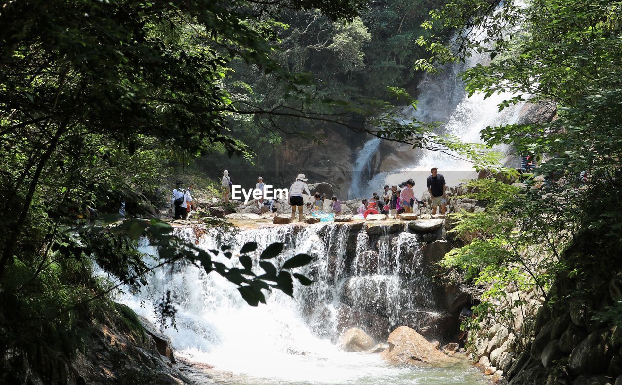 People enjoying at waterfall and river