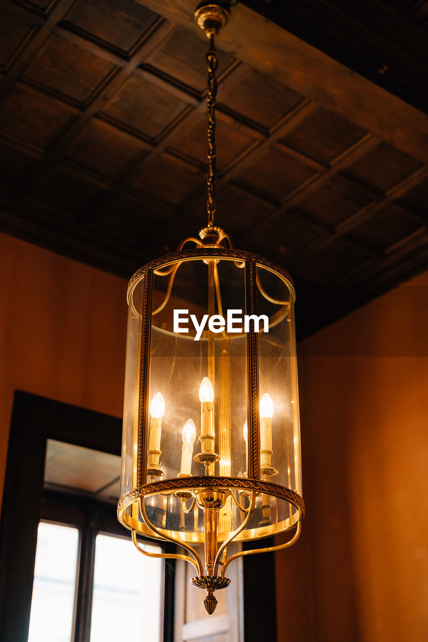 LOW ANGLE VIEW OF ILLUMINATED PENDANT LIGHT