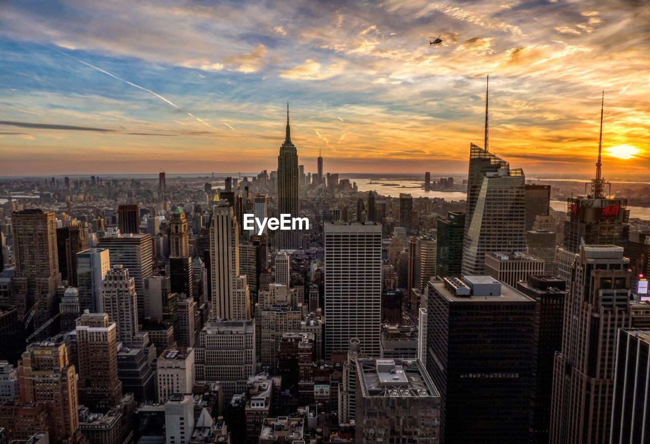 High angle view of empire state building in city against sky during sunset