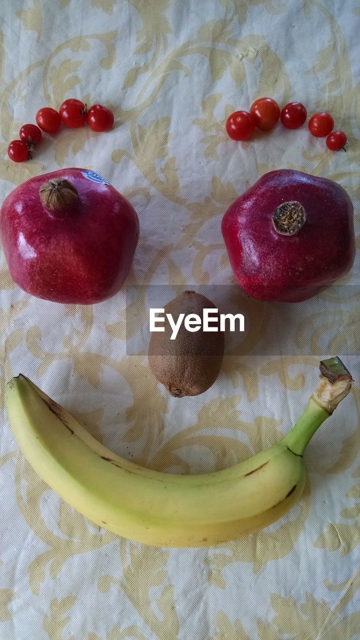 High angle view of human face made by fruits on table