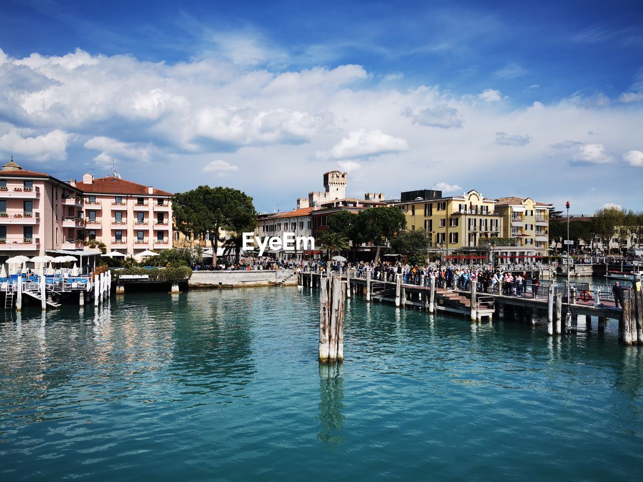 boats in harbor against sky