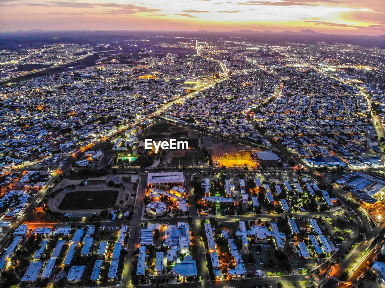 High angle view of city lit up at night