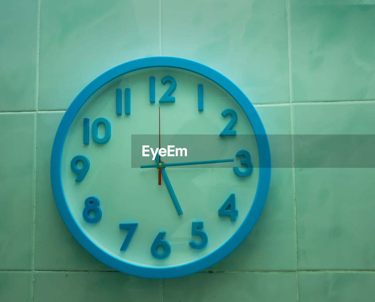 CLOSE-UP OF CLOCK ON WALL