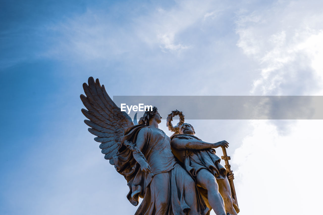 LOW ANGLE VIEW OF STATUES AGAINST SKY