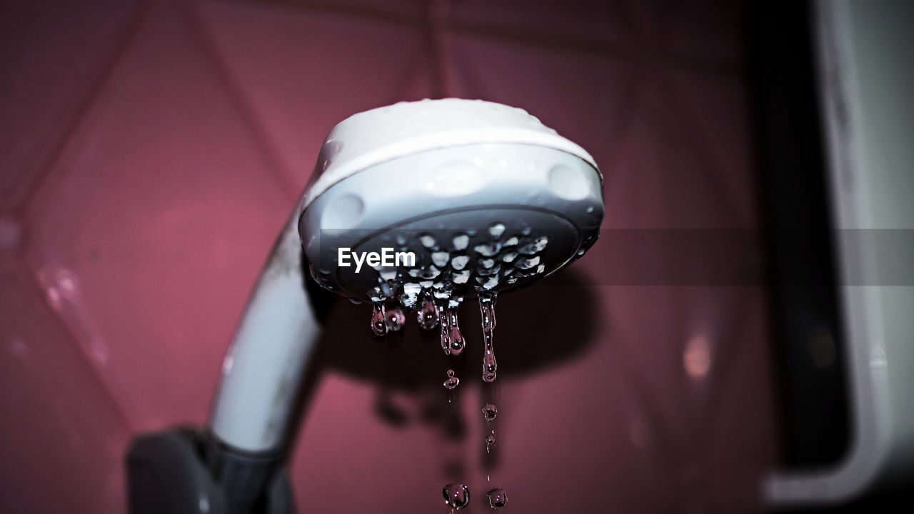 Close-up of hand shower in bathroom