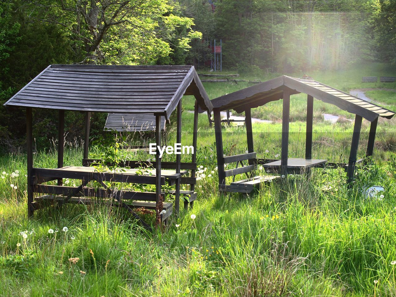 Abandoned picnic tables on grassy field at park