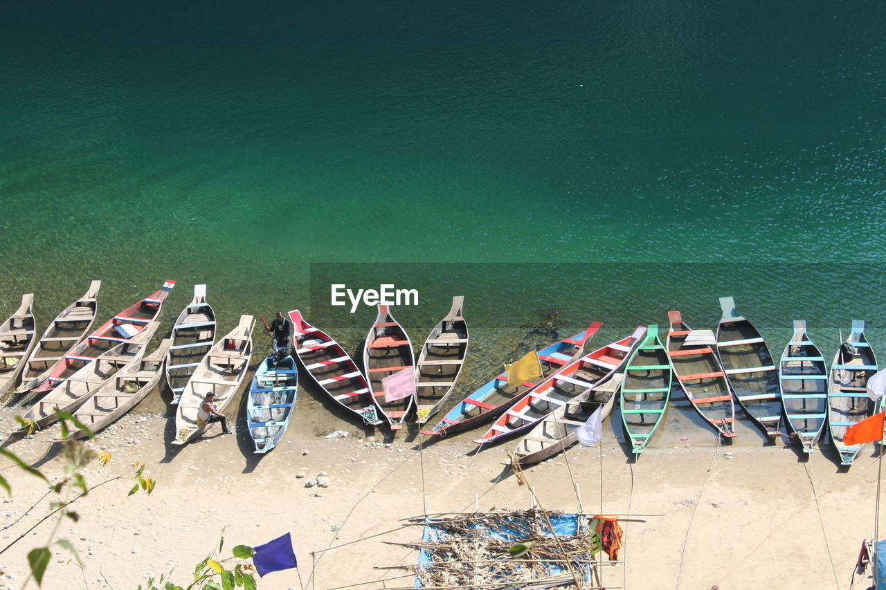 High angle view of boats moored on shore