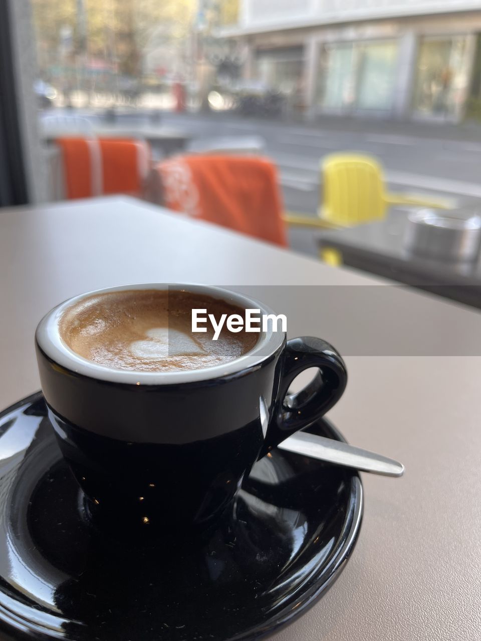 indoors, car, vehicle, food and drink, no people, close-up, drink, household equipment, coffee, cup, focus on foreground, wheel, glass, coffee cup