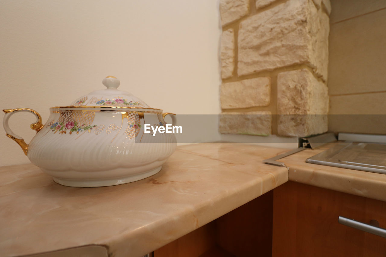 CLOSE-UP OF TEA CUP ON TABLE