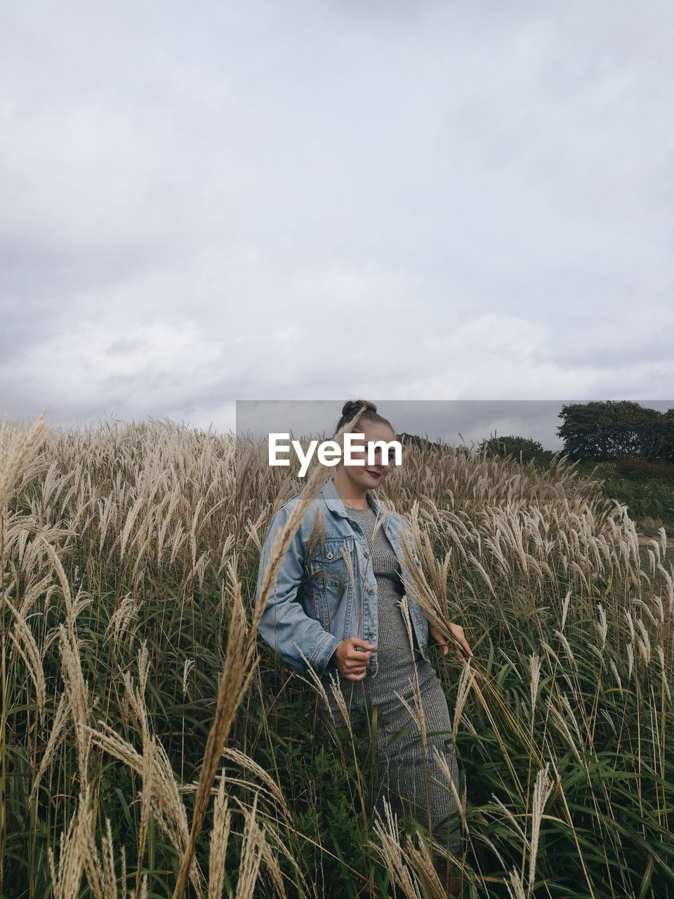 Woman standing on field against sky