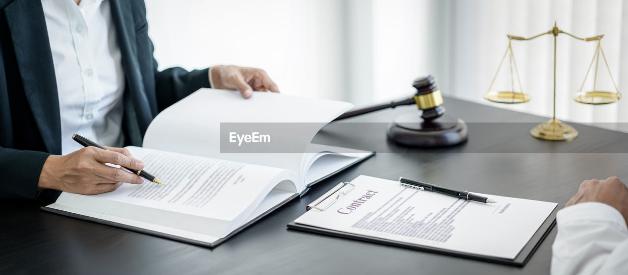 midsection of businessman working at desk in office