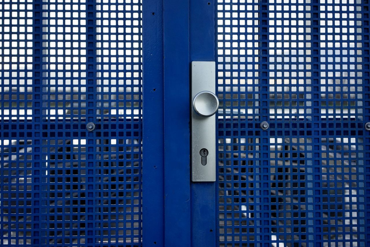 FULL FRAME SHOT OF WINDOW ON BLUE WALL