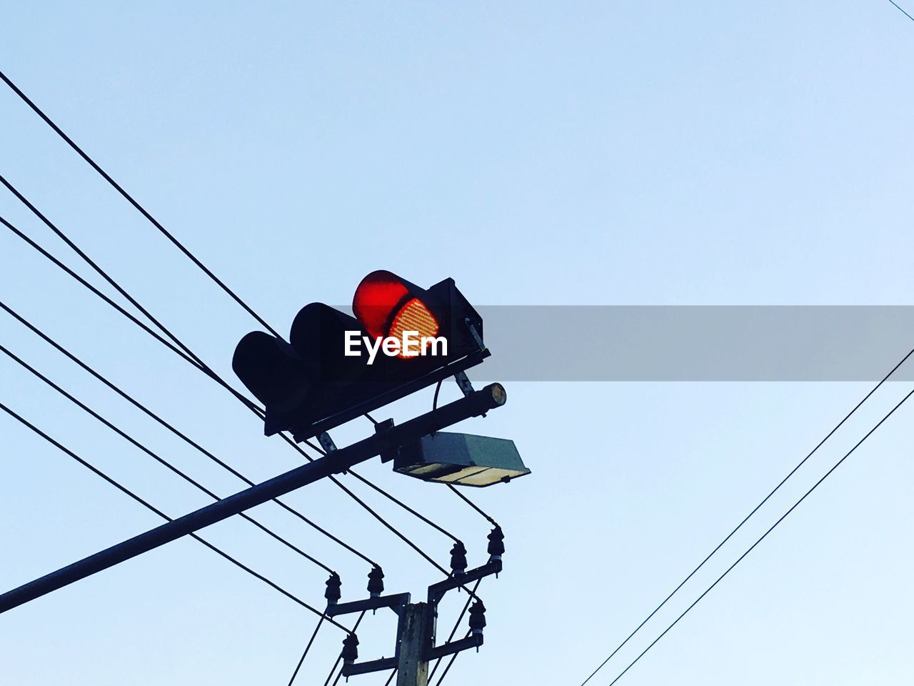 Low angle view of road signal against blue sky