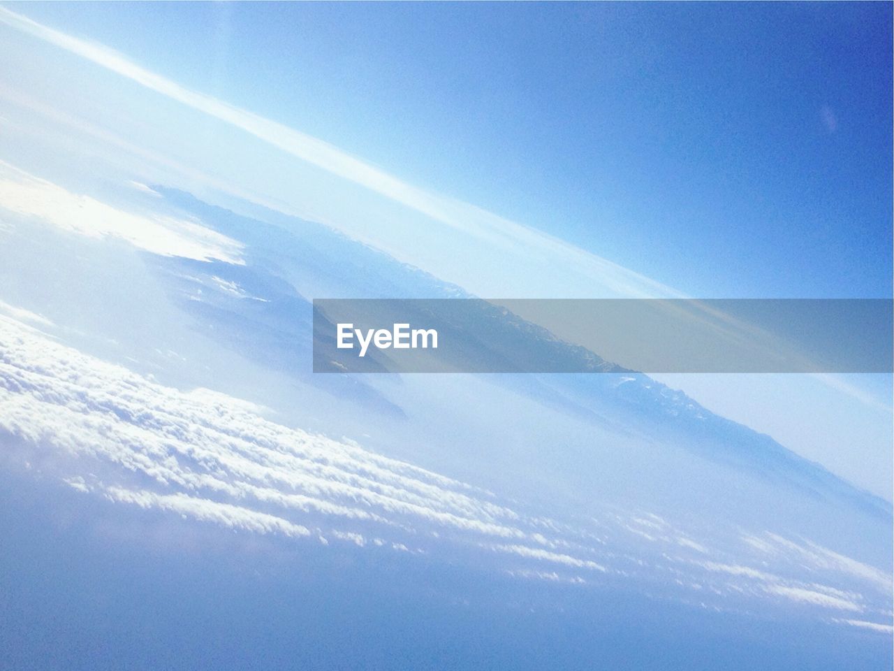 Aerial view of landscape against blue sky