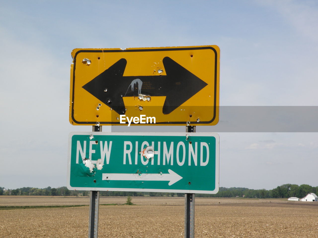 Close-up of road sign against sky