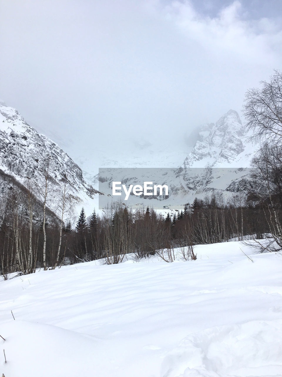 Scenic view of snow covered mountains against sky