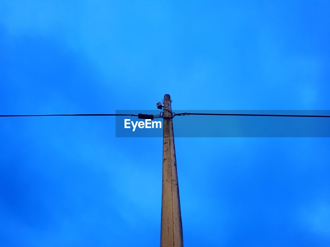 LOW ANGLE VIEW OF POLE AGAINST BLUE SKY