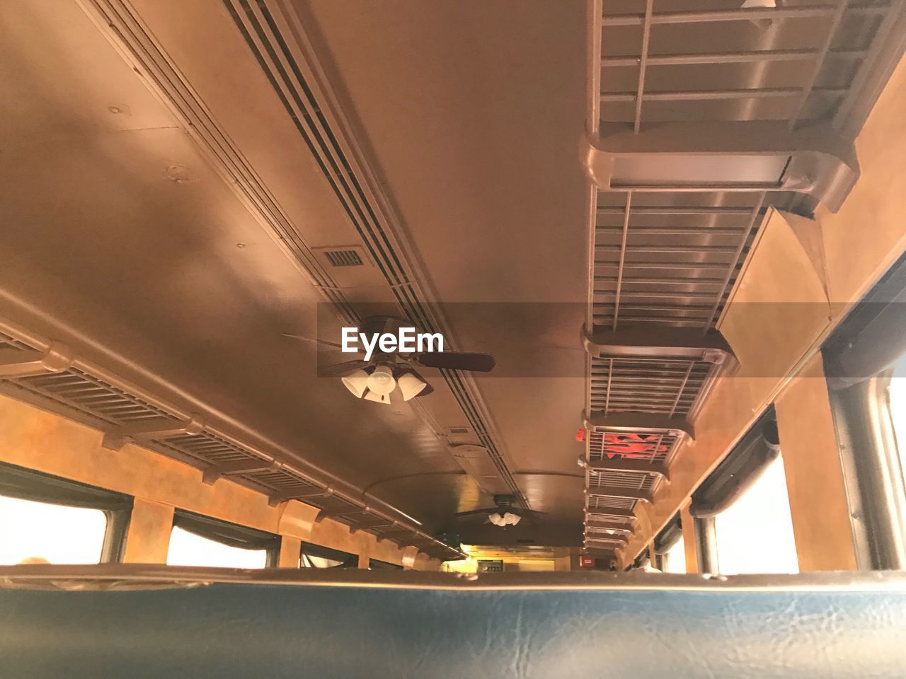 LOW ANGLE VIEW OF ILLUMINATED TRAIN AT RAILROAD STATION