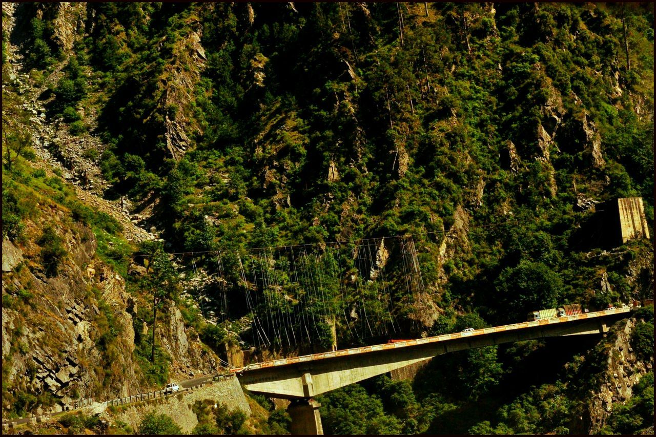 View of bridge by large mountain