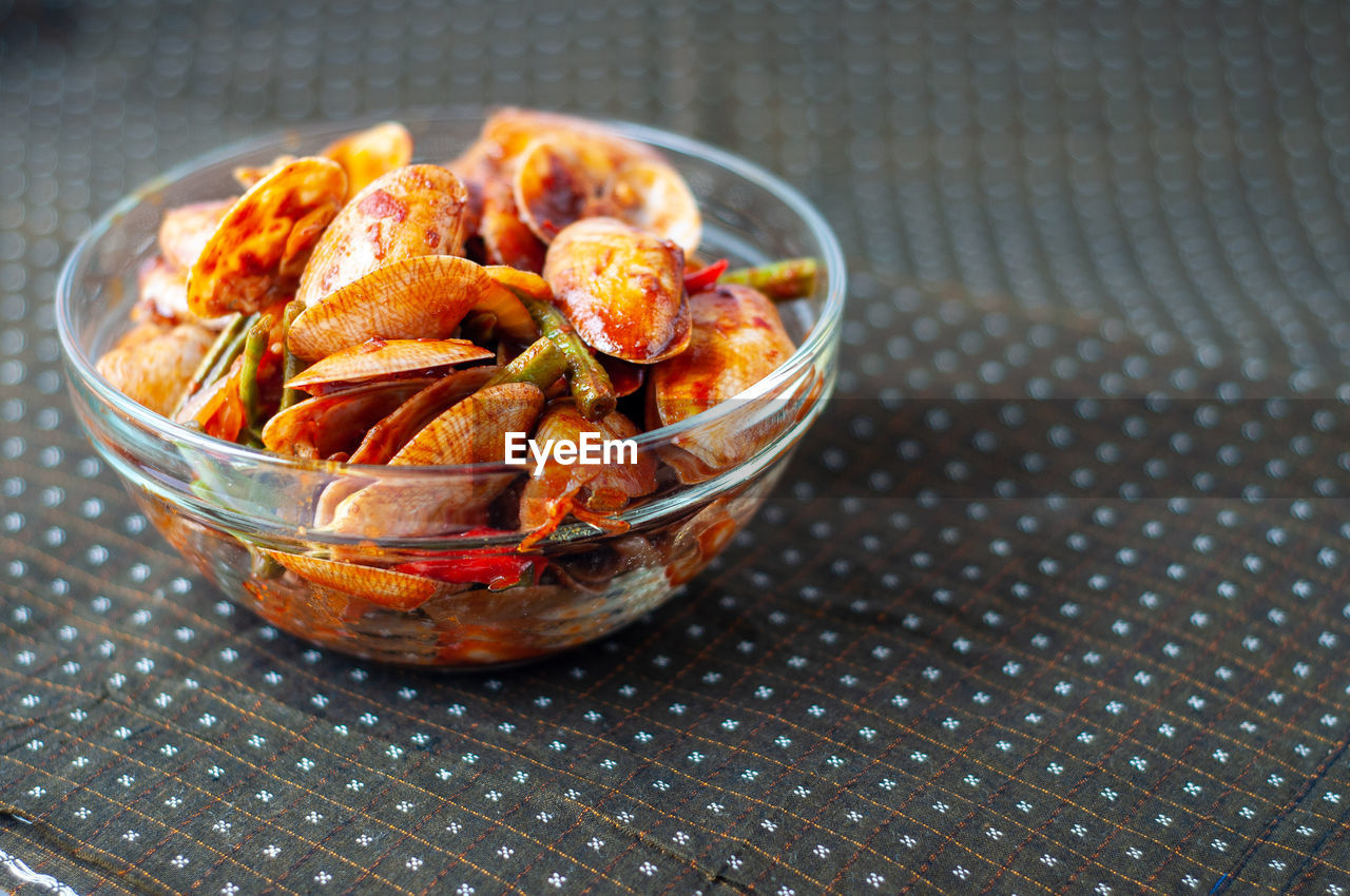 Spicy paphia textile, or known as retak seribu lala fried with chillies. served in a bowl.