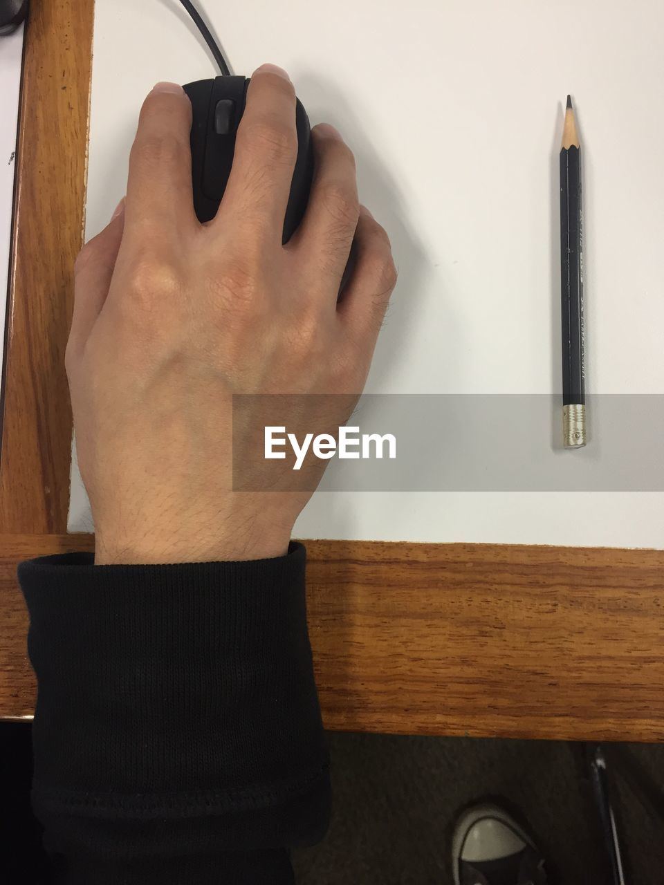 MIDSECTION OF MAN WITH TABLE