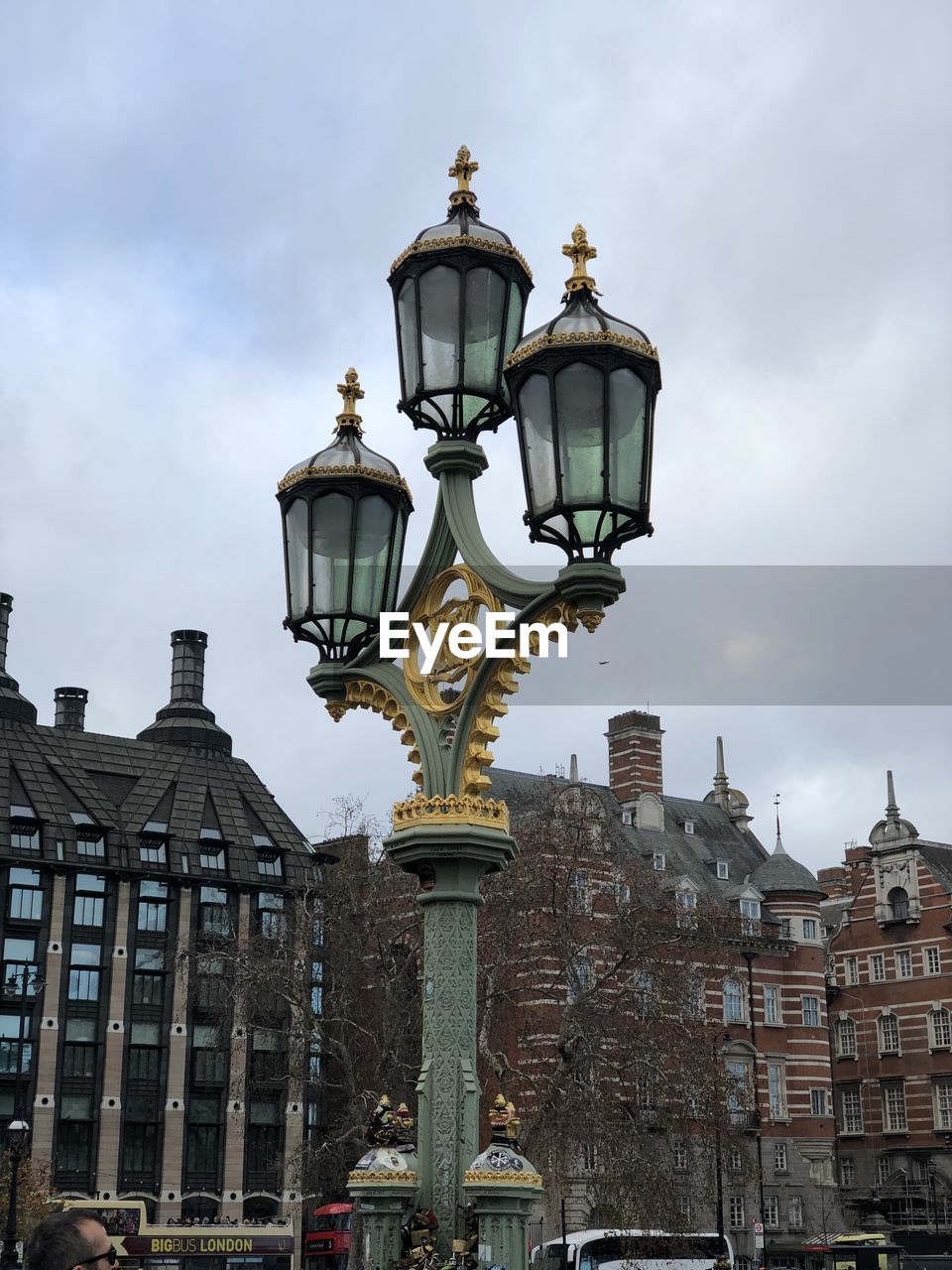 Low angle view of street light against cloudy sky in london