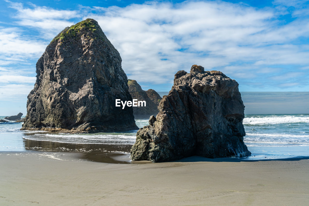 A view of meyers creek beach with waves and rock formations on the coast of oregon state.