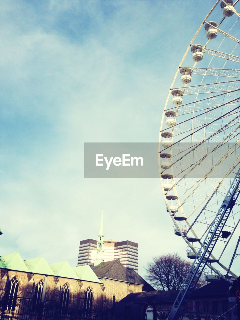 LOW ANGLE VIEW OF FERRIS WHEEL AGAINST THE SKY