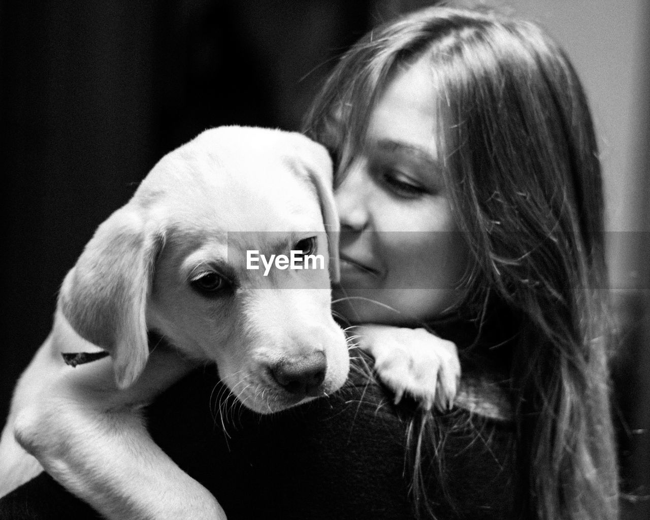 Close-up of young woman with dog at home