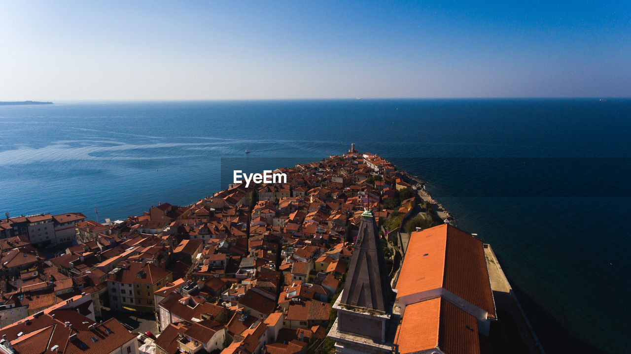 High angle view of buildings in city by sea