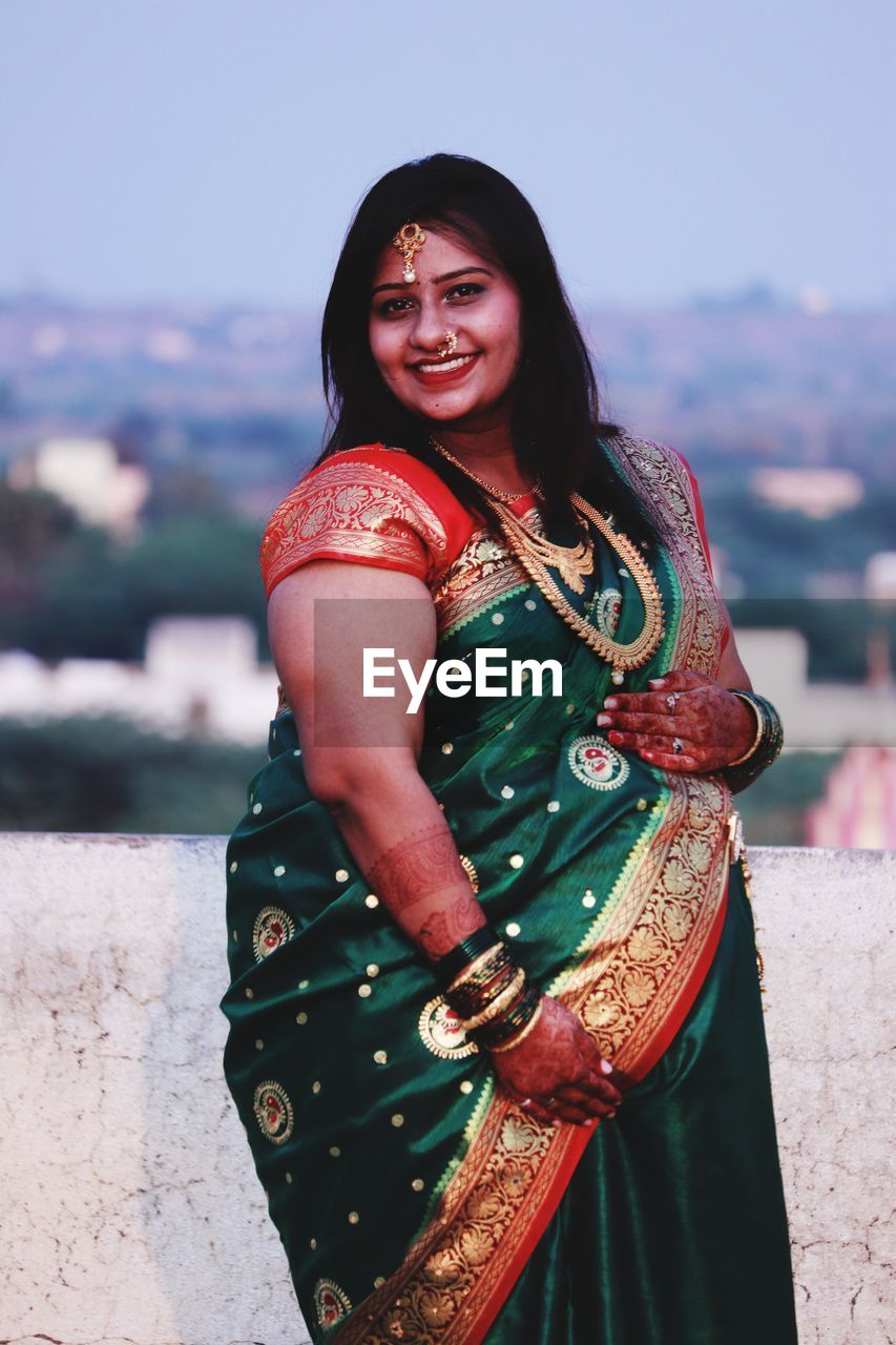 Portrait of smiling woman wearing sari outdoors