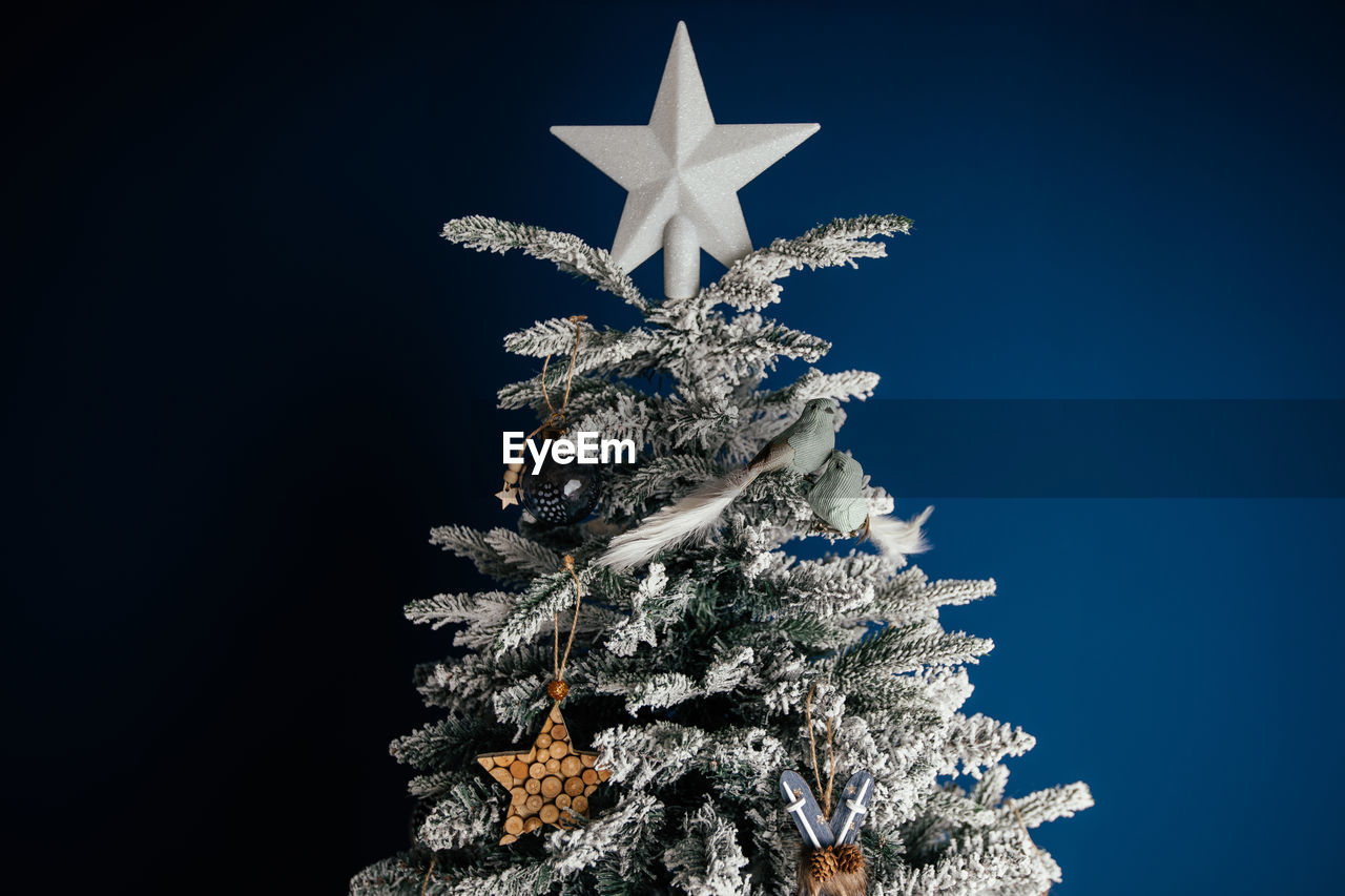 LOW ANGLE VIEW OF CHRISTMAS TREE AGAINST CLEAR SKY DURING WINTER