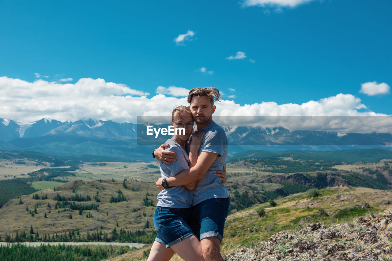 FULL LENGTH OF MAN FRIENDS AGAINST MOUNTAINS