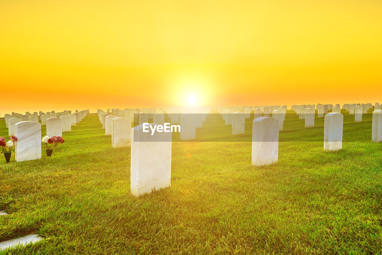 VIEW OF CEMETERY AGAINST SKY DURING SUNSET