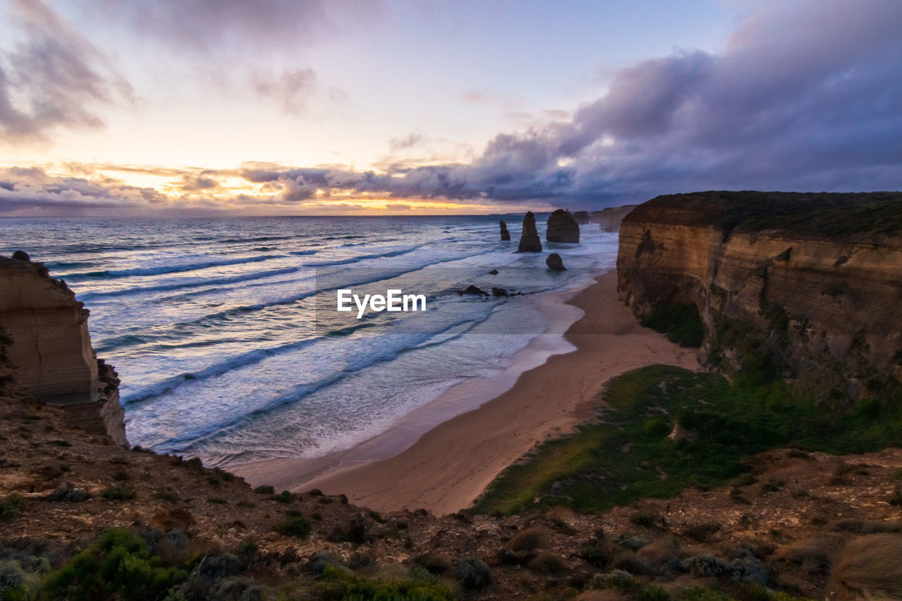 Scenic view of beach against sky during sunset at 12 apostles 